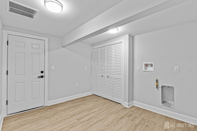 laundry room featuring hookup for a washing machine and light hardwood / wood-style floors