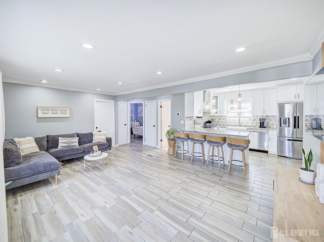 7 Kenneth Ave, Sayreville, NJ 08859 - living area featuring ornamental molding, recessed lighting, and light wood finished floors