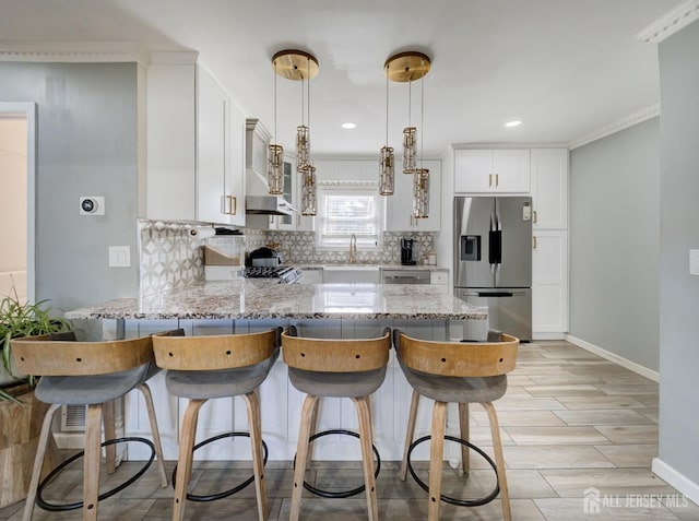 7 Kenneth Ave, Sayreville, NJ 08859 - kitchen with stainless steel refrigerator with ice dispenser, a peninsula, wall chimney exhaust hood, decorative backsplash, and light stone counters
