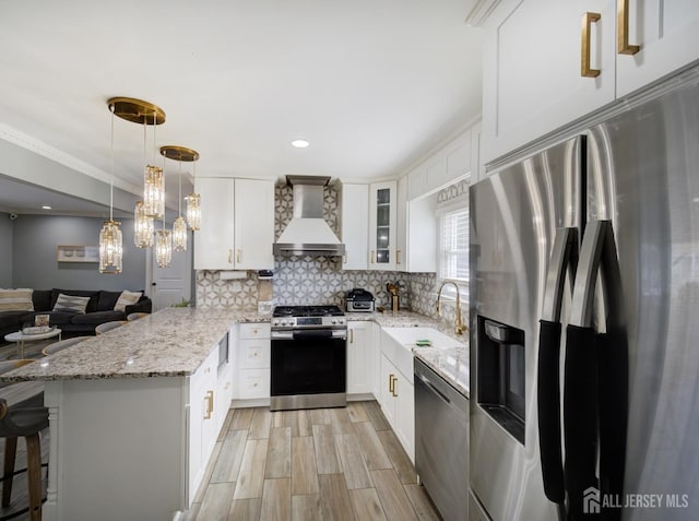 7 Kenneth Ave, Sayreville, NJ 08859 - kitchen with appliances with stainless steel finishes, premium range hood, a sink, a peninsula, and tasteful backsplash