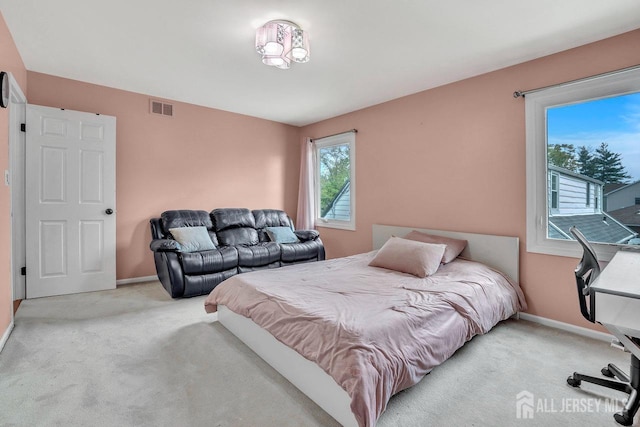 bedroom with carpet floors, baseboards, and visible vents