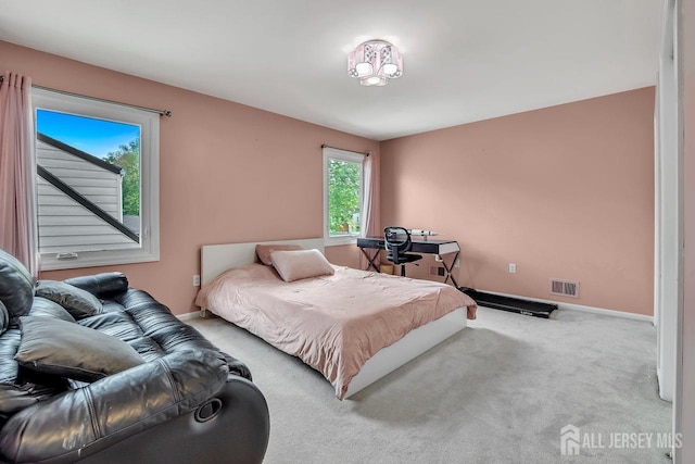 bedroom with carpet floors, baseboards, and visible vents