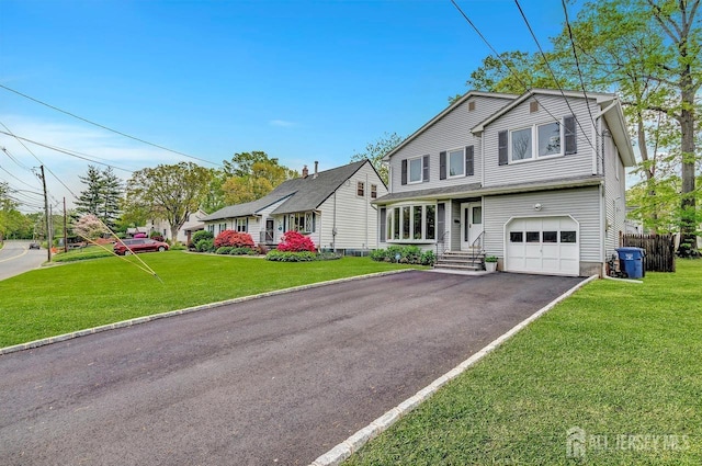 view of front of house with a garage, aphalt driveway, and a front yard