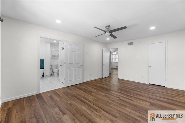 unfurnished bedroom with recessed lighting, wood finished floors, and baseboards