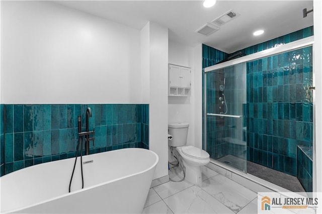 bathroom with a soaking tub, a shower stall, recessed lighting, toilet, and marble look tiles