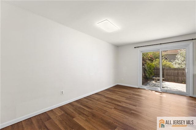 unfurnished room with wood finished floors and baseboards