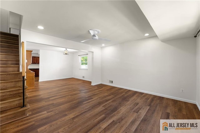 unfurnished living room with ceiling fan, stairway, dark wood-style floors, baseboards, and recessed lighting
