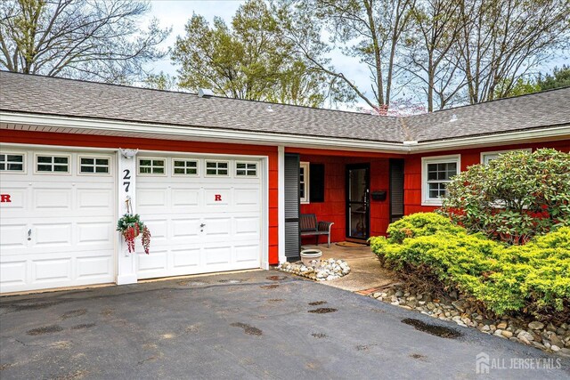 27 Landry Rd, Franklin Twsp, NJ 08873 - view of front facade with driveway, a garage, and roof with shingles