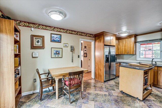 27 Landry Rd, Franklin Twsp, NJ 08873 - kitchen with stainless steel refrigerator with ice dispenser, stone finish flooring, dark countertops, and brown cabinetry