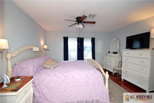 176 Rossmoor Dr Unit C, Monroe, NJ 08831 - bedroom with dark wood-style floors, a textured ceiling, and a ceiling fan