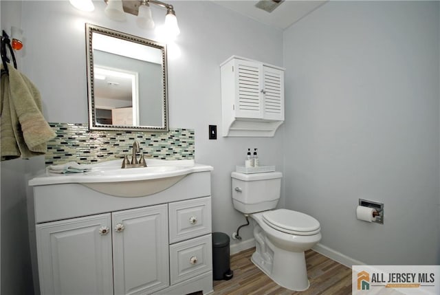 176 Rossmoor Dr Unit C, Monroe, NJ 08831 - bathroom featuring decorative backsplash, toilet, wood finished floors, vanity, and baseboards
