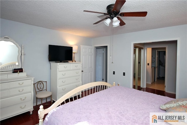 176 Rossmoor Dr Unit C, Monroe, NJ 08831 - bedroom featuring a textured ceiling, a ceiling fan, and wood finished floors