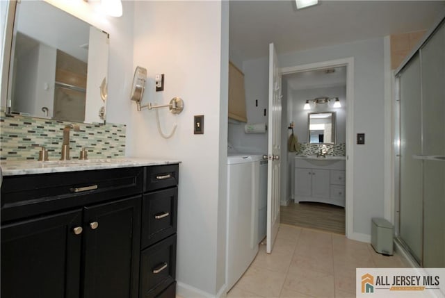 176 Rossmoor Dr Unit C, Monroe, NJ 08831 - bathroom with a shower stall, backsplash, two vanities, and baseboards