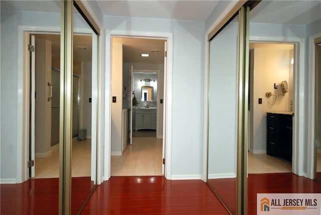 176 Rossmoor Dr Unit C, Monroe, NJ 08831 - corridor with a textured ceiling and tile patterned floors