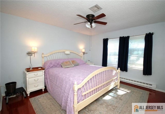 176 Rossmoor Dr Unit C, Monroe, NJ 08831 - bedroom featuring a baseboard radiator, wood finished floors, a textured ceiling, a ceiling fan, and baseboards
