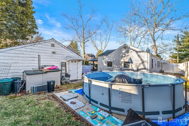 back of house with an outdoor pool and fence