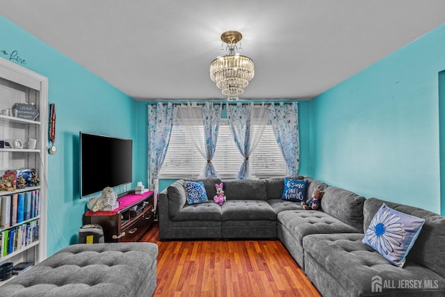 living room featuring a notable chandelier and wood finished floors