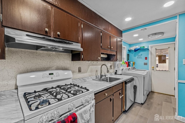 kitchen with dark brown cabinets, ventilation hood, white range with gas cooktop, stainless steel dishwasher, and a sink