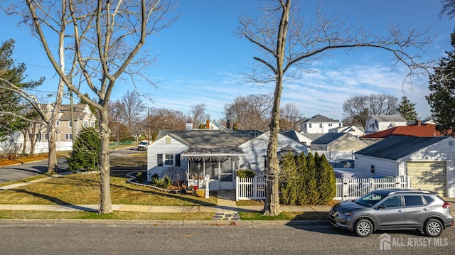 view of front of home with a gate, a residential view, a fenced front yard, and a chimney