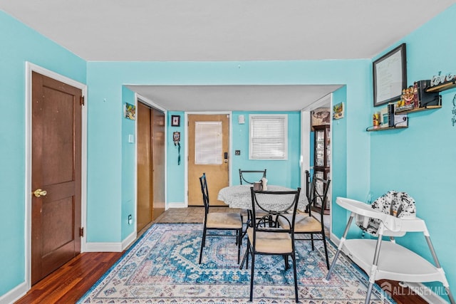 dining room featuring baseboards and wood finished floors