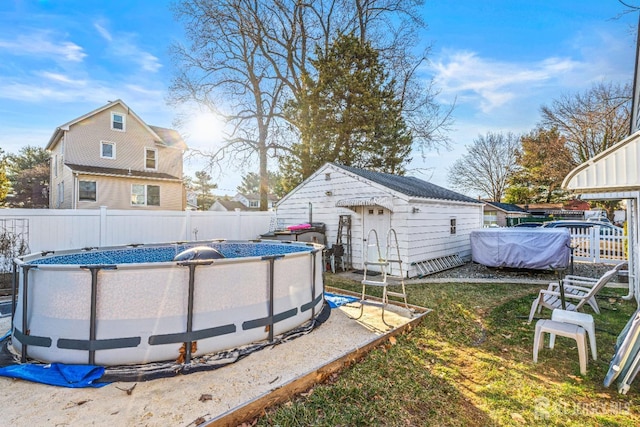 view of yard featuring a fenced in pool, an outdoor structure, and a fenced backyard