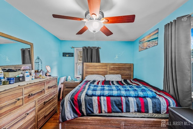 bedroom with a ceiling fan and wood finished floors