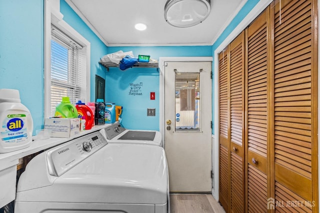 laundry room with washer and dryer, light wood-style flooring, laundry area, and ornamental molding