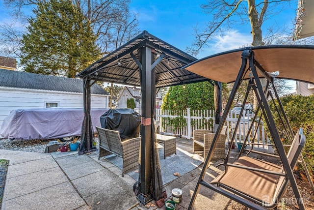 view of patio featuring a grill and fence