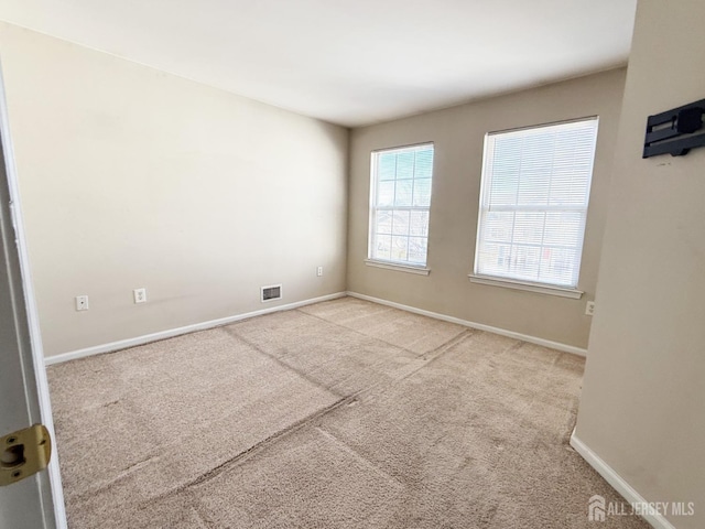 spare room with light colored carpet