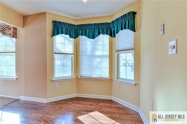 unfurnished dining area with hardwood / wood-style flooring and a healthy amount of sunlight