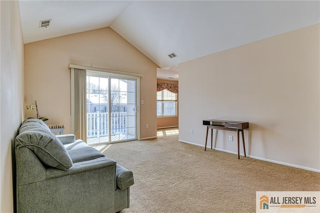 living area with vaulted ceiling and carpet