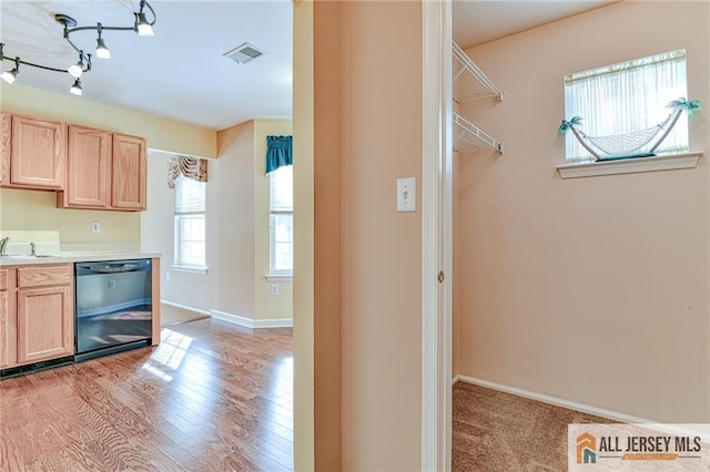 kitchen featuring sink, light hardwood / wood-style floors, dishwasher, and light brown cabinets