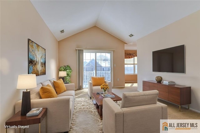 carpeted living room featuring lofted ceiling