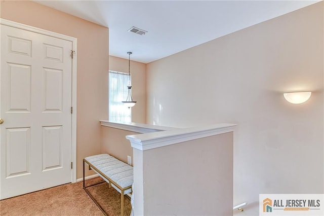 hallway with light colored carpet