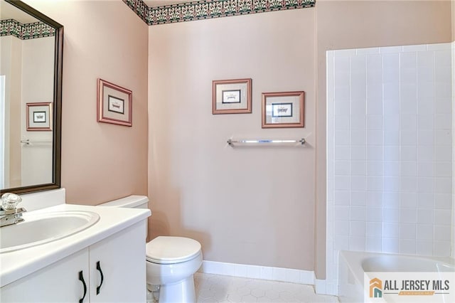 bathroom featuring tile patterned flooring, vanity, and toilet