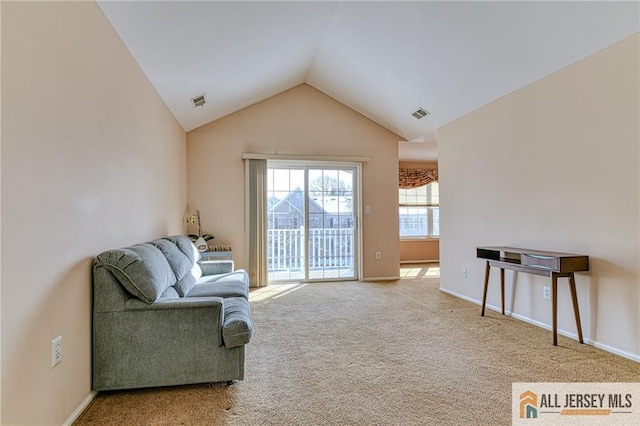 sitting room with vaulted ceiling and carpet