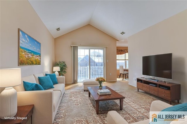 living room with vaulted ceiling and light carpet