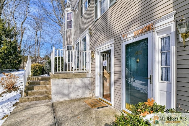 view of snow covered property entrance