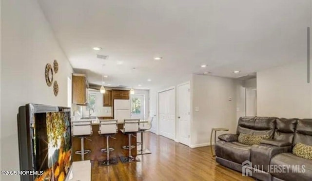 106 Manalapan Rd, Spotswood, NJ 08884 - living room with dark wood-style flooring and recessed lighting
