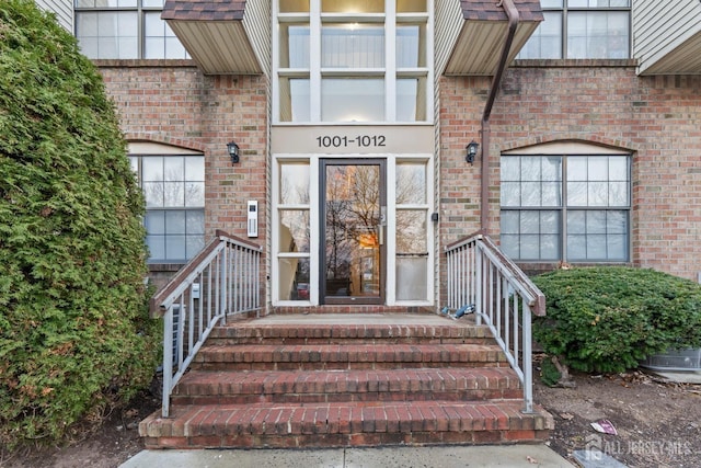 view of exterior entry with brick siding