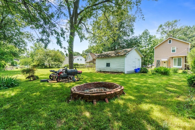 373 Rushmore Ave, Piscataway, NJ 08854 - view of grassy yard featuring an outdoor fire pit and an outdoor structure