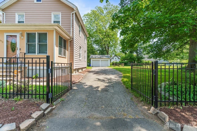 373 Rushmore Ave, Piscataway, NJ 08854 - view of property exterior with a garage, a fenced front yard, an outdoor structure, and a gate