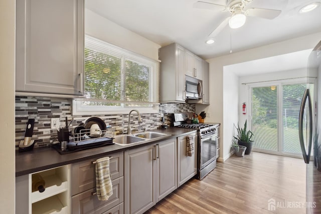 373 Rushmore Ave, Piscataway, NJ 08854 - kitchen with appliances with stainless steel finishes, dark countertops, decorative backsplash, light wood-style flooring, and recessed lighting