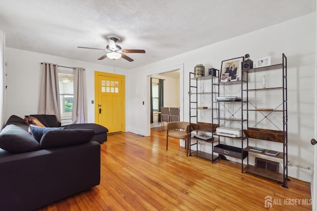 373 Rushmore Ave, Piscataway, NJ 08854 - living room with a textured ceiling, ceiling fan, and light wood-style floors