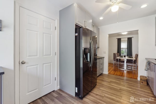 373 Rushmore Ave, Piscataway, NJ 08854 - kitchen with stainless steel fridge with ice dispenser, light wood-style floors, a ceiling fan, white cabinets, and recessed lighting