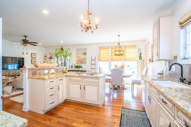 105 Recklesstown Way, Chesterfield, NJ 08515 - kitchen with hanging light fixtures, light stone countertops, light wood-type flooring, a sink, and recessed lighting