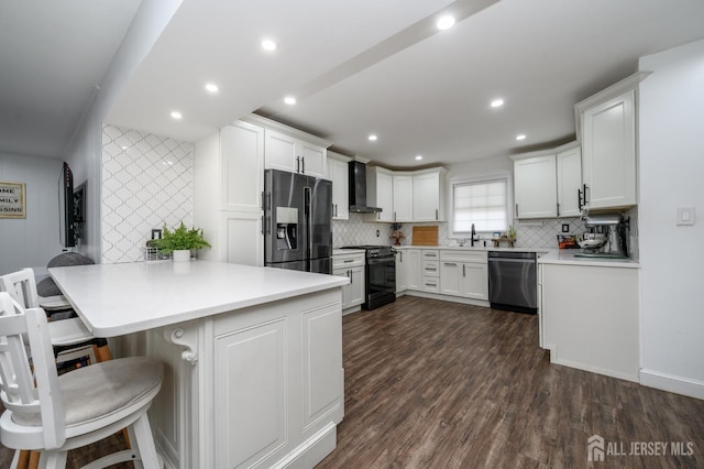 18 Chipper Dr, South Brunswick, NJ 08824 - kitchen featuring stainless steel dishwasher, black range oven, wall chimney range hood, a peninsula, and dark wood-style floors