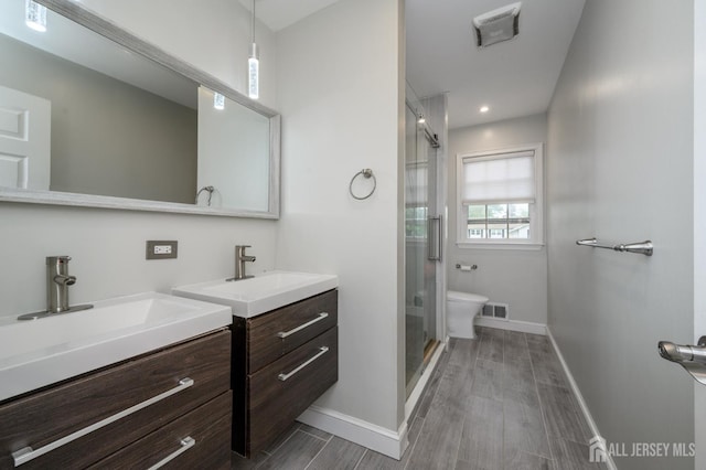 18 Chipper Dr, South Brunswick, NJ 08824 - bathroom with two vanities, a shower stall, and wood finished floors