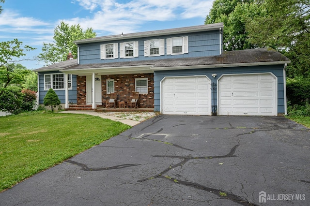 18 Chipper Dr, South Brunswick, NJ 08824 - traditional home featuring asphalt driveway, a front lawn, covered porch, brick siding, and a garage