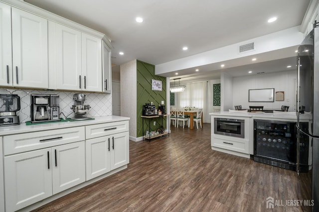 18 Chipper Dr, South Brunswick, NJ 08824 - kitchen with wine cooler, white cabinets, light countertops, backsplash, and recessed lighting